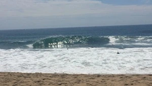 Live look at huge waves as they compress and rise adjacent to the rocky jetty.