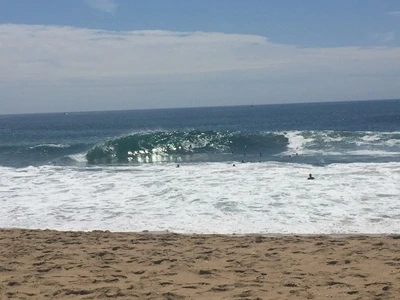 Huge waves breaks at the Wedge in Newport beach and surfers try to catch a ride