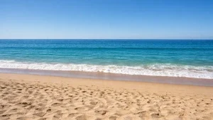 Close up, ground level view of the beach and surf in Aliso Beach, California.