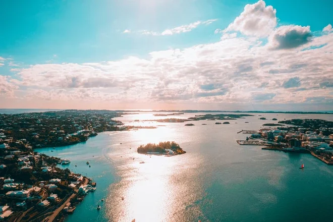 Aerial view of the harbor in Bermuda with the sun shining through the clouds and reflecting off of the water