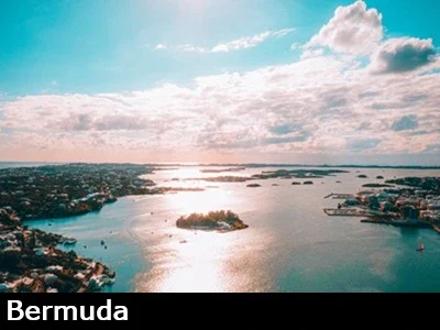 Aerial view of the harbor in Bermuda with the sun shining through the clouds and reflecting off of the water