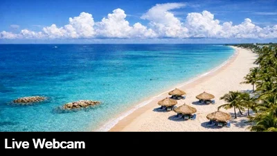 Live view looking down at the beach and palapas at the Casa del Mar Resort in Aruba.