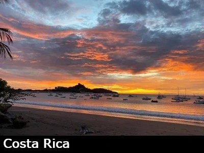 View looking south towards Playa Flamingo Costa Rica and the marina during a vivid orange and yellow sunset