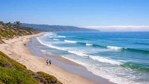 Live view of Del Mar beach and surf looking towards La Jolla with the marine layer hugging the coast.