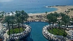 Live view overlooking the infinity pool with the beach and ocean in the background.