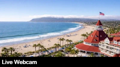 Live view of the beach from the Hotel del Coronado with Point Loma in the background.