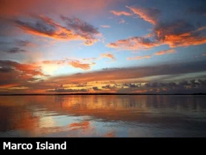 Beautiful orange and yellow sunset reflecting on the water in Marco Island Florida