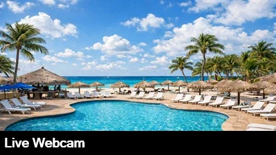 Live view of the pool and spa area with the beautiful Caribbean in the background.