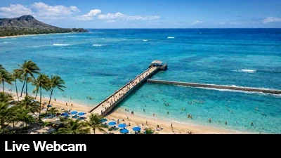 Beautiful view from the top of the Park Shore Waikiki Hotel in Oahu, Hawaii looking down from the top at the beach, pier and surf break jetty.