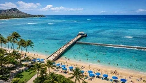 Beautiful view from the top of the Park Shore Waikiki Hotel in Oahu, Hawaii looking down from the top at the beach, pier and surf break jetty.