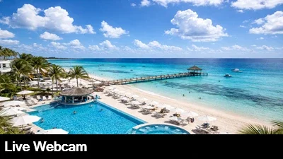 Live view of the pool, beach and boat dock from the Playcar Palace webcam in Playa del Carmen, Mexico.