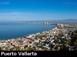 View from above looking down towards downtown Puerto Vallarta and the calm Pacific Ocean