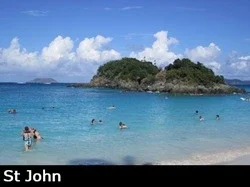 Snorkelers swim around St John's famous Trunk By with its clear, turquoise waters