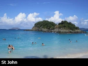 Snorkelers swim around St John's famous Trunk By with its clear, turquoise waters