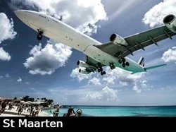 A large commercial airliner lands in St Maarten just feet above famous Maho beach