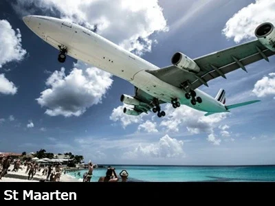 A large commercial airliner lands in St Maarten just feet above famous Maho beach