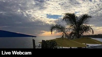Live view of the beach below from the Cliff Restaurant high above the Pacific Ocean.