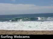 Huge waves breaks at the Wedge in Newport beach and surfers try to catch a ride