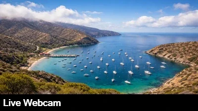 Live view from the surrounding hills looking down at the pier and boats moored at Two Harbors in Catalina Island, California.