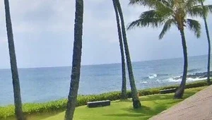 Live view of the Pacific ocean and boardwalk area from the Whalers Cove webcam in Kauai, Hawaii